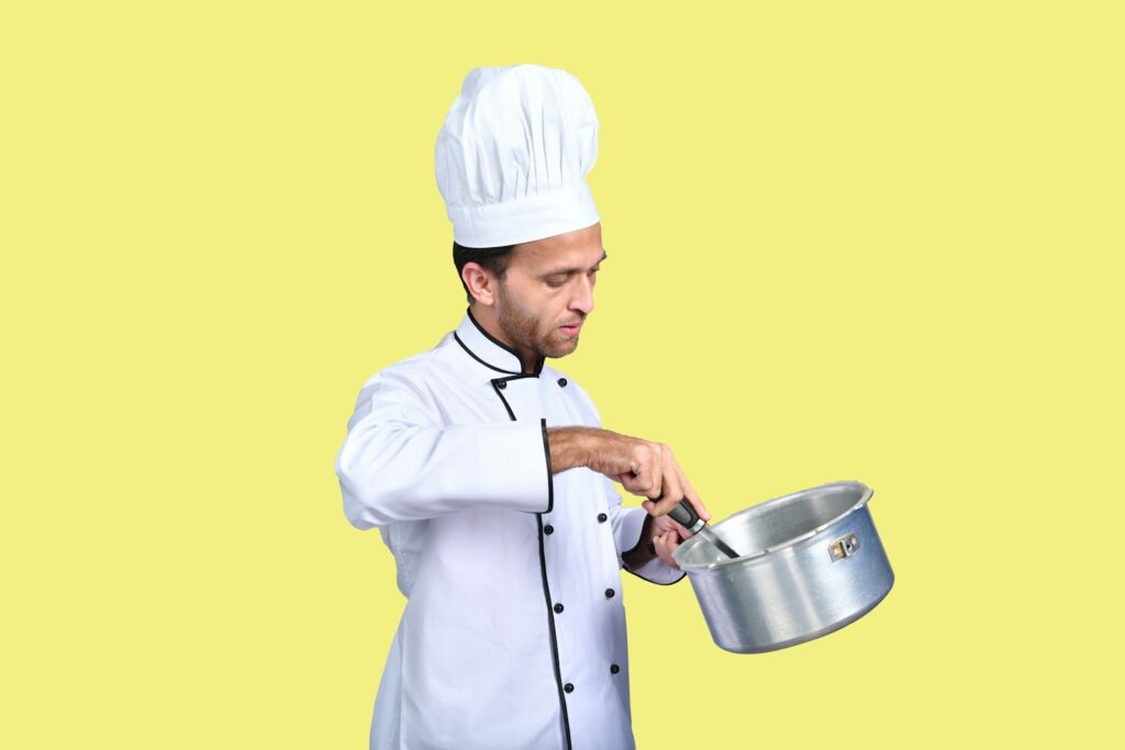 a chef holding a pot
