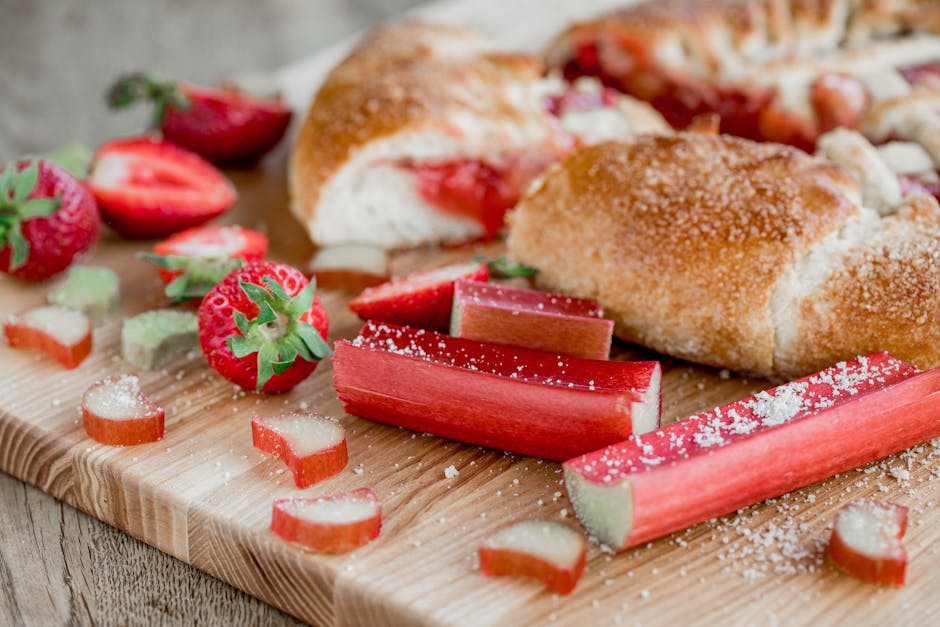 Fresh strawberries and rhubarb on a rustic tart preparation