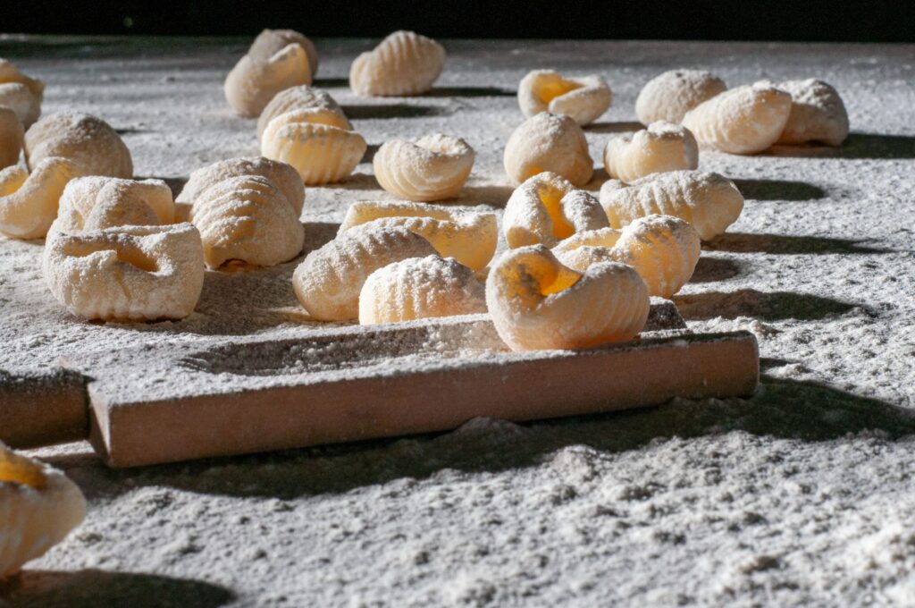 Gros plan de gnocchis faits maison sur une surface farinée, parfait pour l'inspiration culinaire.